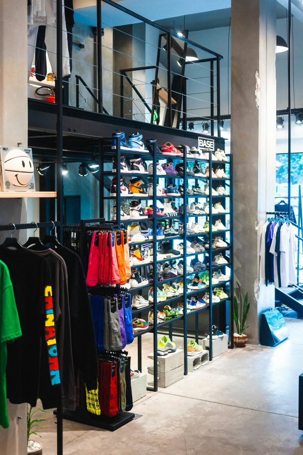 Interior of a modern store showcasing streetwear and footwear on shelves.