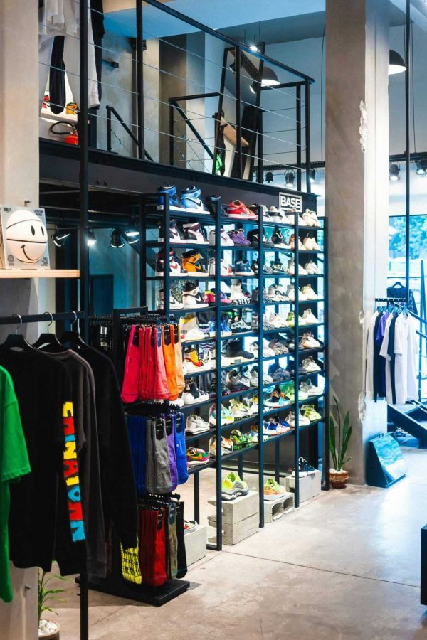 Interior of a modern store showcasing streetwear and footwear on shelves.