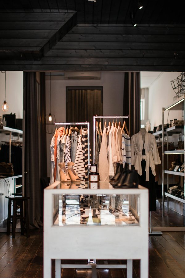 Explore the chic interior of a modern fashion retail store with clothing displays.