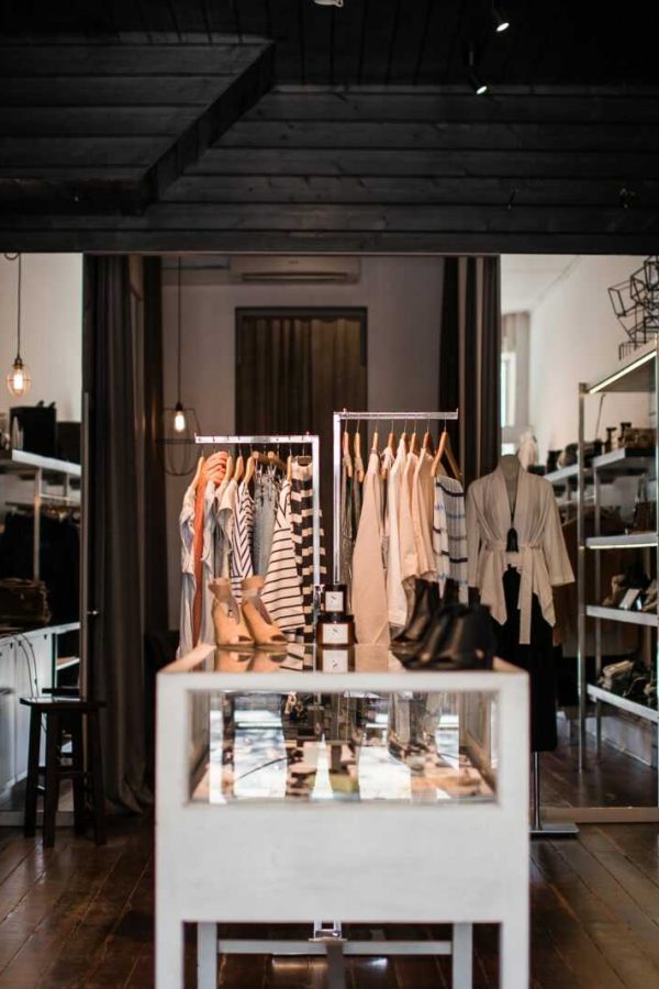 Explore the chic interior of a modern fashion retail store with clothing displays.